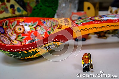 Vladimir, Russia - March 29, 2019: Funny bearded hipster lego-man minifigure with small souvenir spoon in Spoon Museum Editorial Stock Photo