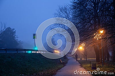 Selective blur on a woman walking alone disappearing and fading Editorial Stock Photo