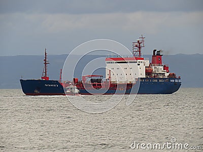 Vladivostok, Primorsky kray / Russia - September 23 2018: Oil product tanker Taganroga at anchor and pilot boat in roadstead of po Editorial Stock Photo