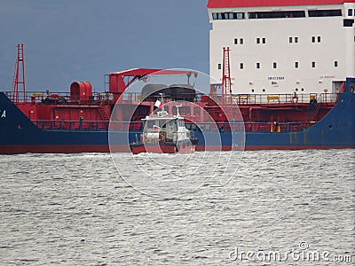 Vladivostok, Primorsky kray / Russia - September 23 2018: Oil product tanker Taganroga at anchor and pilot boat in roadstead of po Editorial Stock Photo