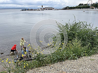 Vladivostok, Russia, August, 29, 2022. Women relax on the seashore near the Sports embankment in Vladivostok in the summer Editorial Stock Photo