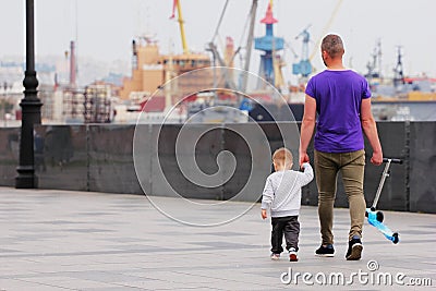 Vladivostok, Russia - 3 Jun 2019 : Father with a small child walking along the promenade. Without mom Editorial Stock Photo