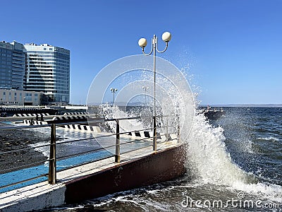 Vladivostok, Russia, October, 10, 2023. Waves on the Sports embankment against the background of the Barny apart-hotel Editorial Stock Photo