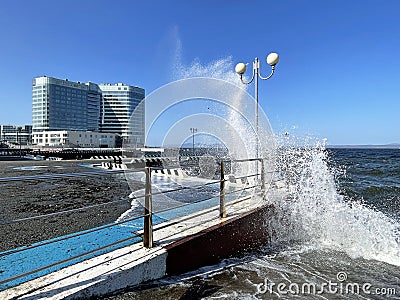 Vladivostok, Russia, October, 10, 2023. Waves on the Sports embankment against the background of the Barny apart-hotel Editorial Stock Photo