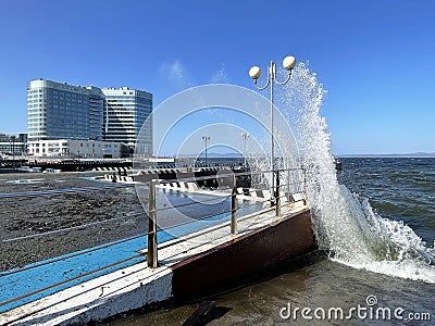 Vladivostok, Russia, October, 10, 2023. Waves on the Sports embankment against the background of the Barny apart-hotel Editorial Stock Photo