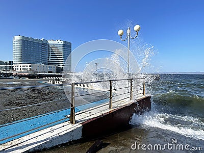 Vladivostok, Russia, October, 10, 2023. Waves on Sports embankment against the background of the Barny apart-hotel Editorial Stock Photo