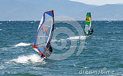 Windsurfers on the waves of the Amur Bay on a cold windy autumn day Editorial Stock Photo