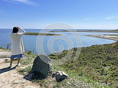 Vladivostok, Russia, September, 22,09, 2023. Woman admires Akhlestyshev Bay from a high point in autumn Editorial Stock Photo