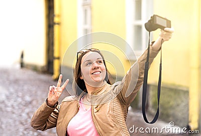 Vlogger filming video blog in city. Young smiling happy woman. Stock Photo