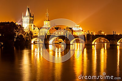 Vltava River and Charles Bridge with Old Town Bridge Tower by night, Prague, Czechia. UNESCO World Heritage Site Stock Photo