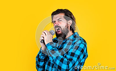 vocal exercise. music. mature man sing a song. vocal classes. style of music. bearded man sing in microphone. brutal guy Stock Photo