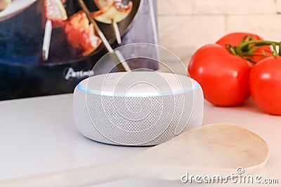 Amazon echo dot , Alexa voice controlled speaker with activated voice recognition, on brick and white background Editorial Stock Photo