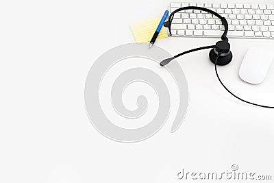 VOIP headset, pen and paper note on laptop computer keyboard. Communication support for callcenter and customer service Helpdesk. Stock Photo