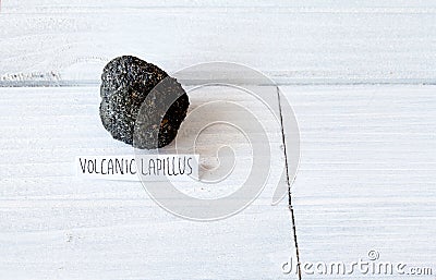 Volcanic Lapillus on white wood table Stock Photo