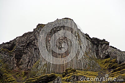 Volcanic mountain with basalt columns wall. Stock Photo