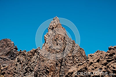 Volcanic rock , layered volcanic rock in desert with mountain landscape and blue sky Stock Photo