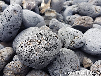 Volcanic rocks rounded by the aleaje of the sea on a beach in Lanzarote, Spain Stock Photo