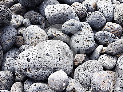 Volcanic rocks rounded by the aleaje of the sea on a beach in Lanzarote, Spain Stock Photo