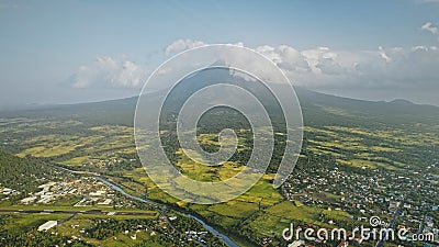 Volcano erupt at countryside cityscape aerial. Urban cottages with traffic road at green valley Stock Photo