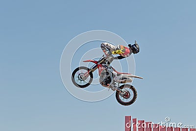 Tricks on a motorcycle jump performed by the athletes during the Editorial Stock Photo