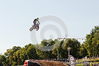 Tricks on a motorcycle jump performed by the athletes during the Editorial Stock Photo