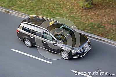 Volkswagen Passat B7 Variant taxi vehicle with motion blur effect Editorial Stock Photo