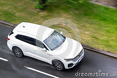 Volkswagen Touareg CR SUV driving quickly in rain with motion blur effect Editorial Stock Photo