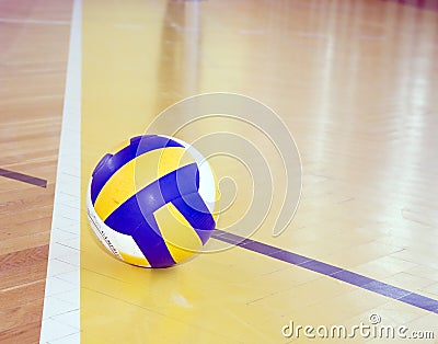 Volleyball on hardwood floor Stock Photo