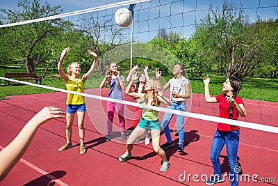 Volleyball net view on girls trying to catch ball Stock Photo