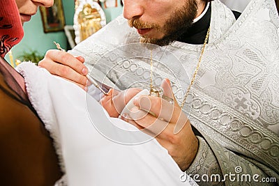 Ceremony of christening the little girl at church Editorial Stock Photo