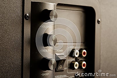 Volume, treble and bass controls on the back of the powerful subwoofer. Vertical arrangement of volume and tone controls on high- Stock Photo