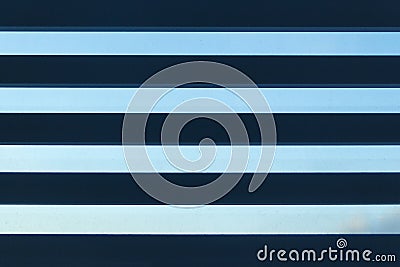 Abstract background. Volumetric stripes on a blue sky background. Horizontal Blinds. Stock Photo