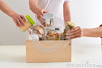 Volunteer with box of food for poor. Donation concept. Stock Photo