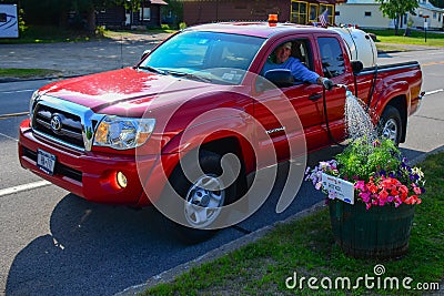 Volunteer concept watering the flowers Editorial Stock Photo