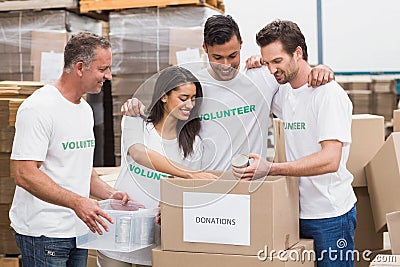 Volunteer team packing a food donation box Stock Photo