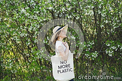 Volunteer woman is cleansed in the spring forest. Earth day and environmental improvement concept. Stock Photo