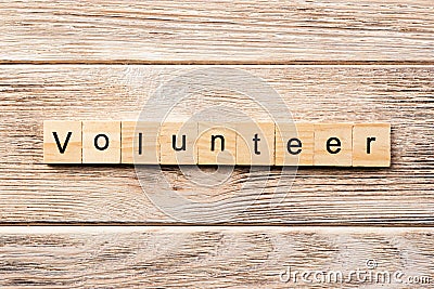 Volunteer word written on wood block. volunteer text on table, concept Stock Photo