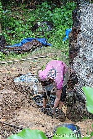 Volunteer working on building an Earthship in Aguada, Puerto Rico Editorial Stock Photo