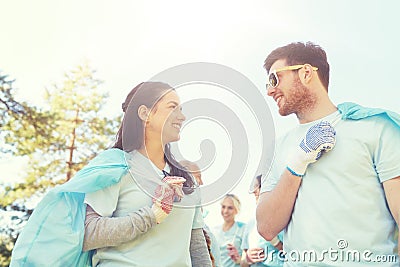 Volunteers with garbage bags talking outdoors Stock Photo