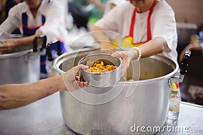 Volunteers are giving food to the homeless poor : the concept of humane Stock Photo