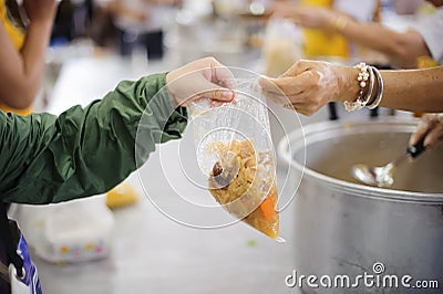 Volunteers are giving food to the homeless poor : the concept of humane Stock Photo
