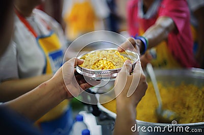 Volunteers are giving food to the homeless poor : the concept of humane Stock Photo