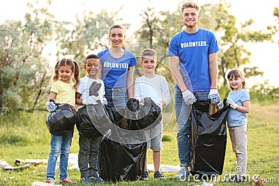 Volunteers with kids collecting trash Stock Photo