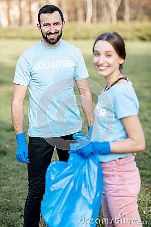 Volunteers portrait with rubbish bags in the park Stock Photo