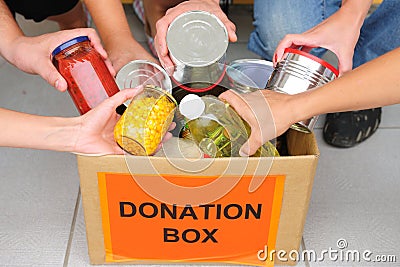 Volunteers putting food in donation box Stock Photo