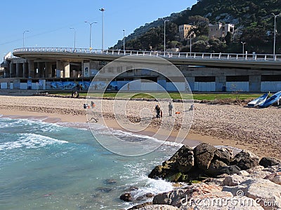 Volunteers remove oil products from a polluted beach and sea in Haifa, Israel. Editorial Stock Photo