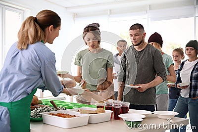 Volunteers serving food for poor people Stock Photo