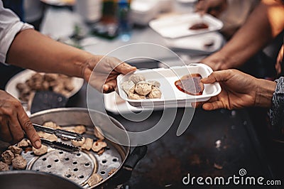 Volunteers share food aid with the poor in the community Stock Photo