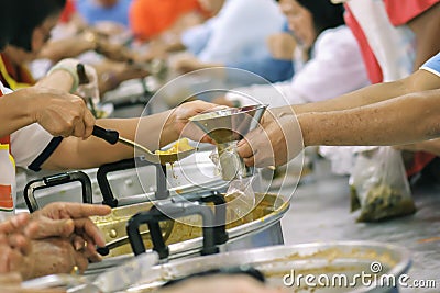 Volunteers Share Food to the Poor to Relieve Hunger: Charity concept Stock Photo