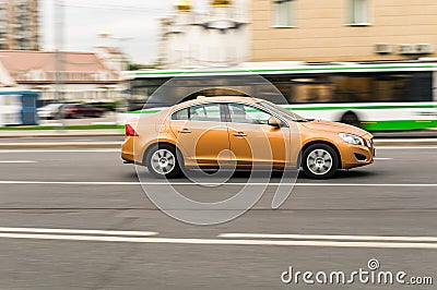 Volvo S60 T4 side view. Orange compact executive car second generation in motion Editorial Stock Photo